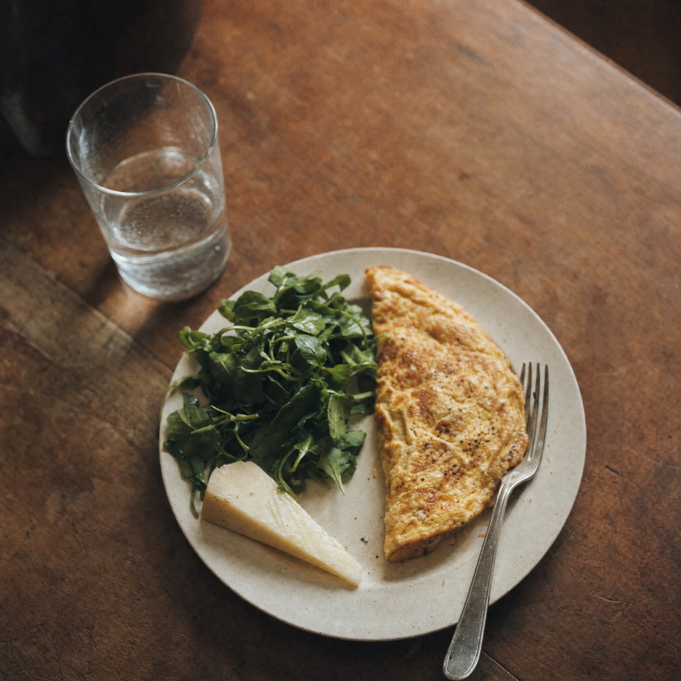 A plated dinner on a worn wooden table